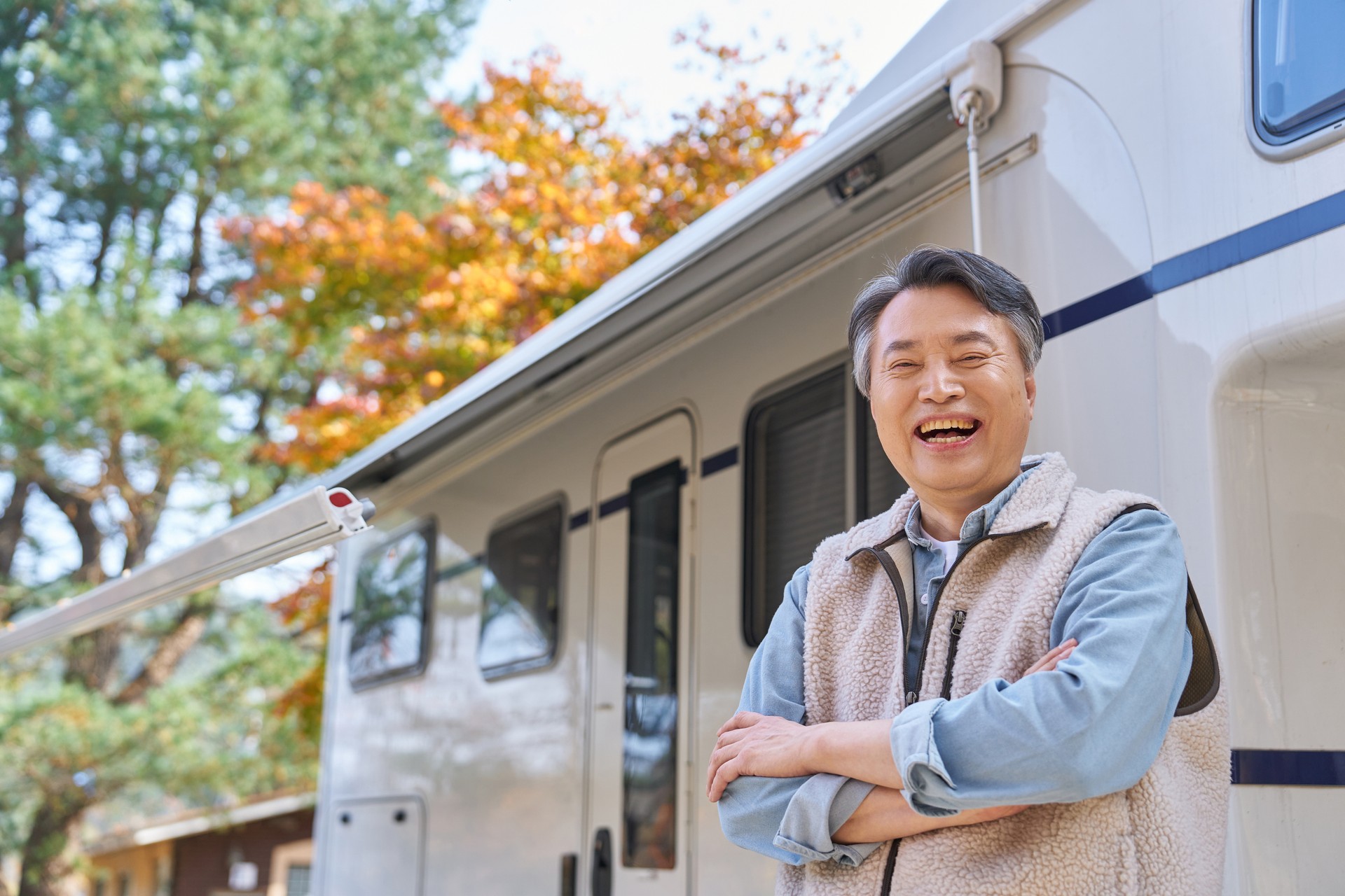 elderly man standing aside his RV