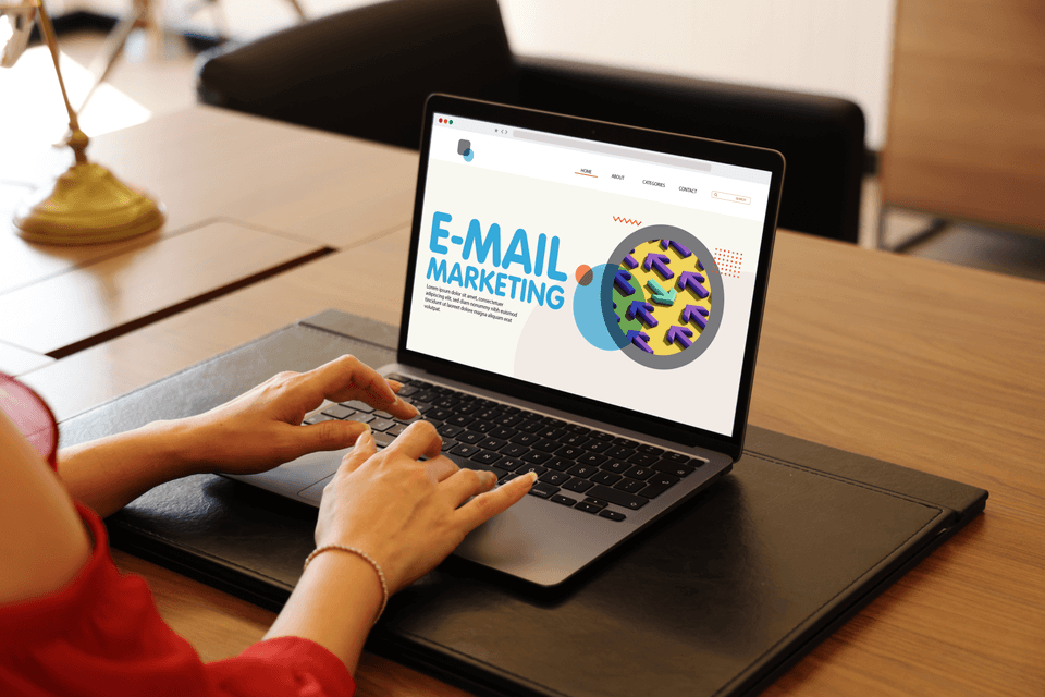 person at a laptop computer with email marketing campaign