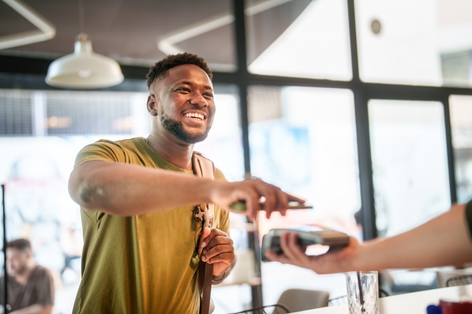 man making a retail purchase with smart phone