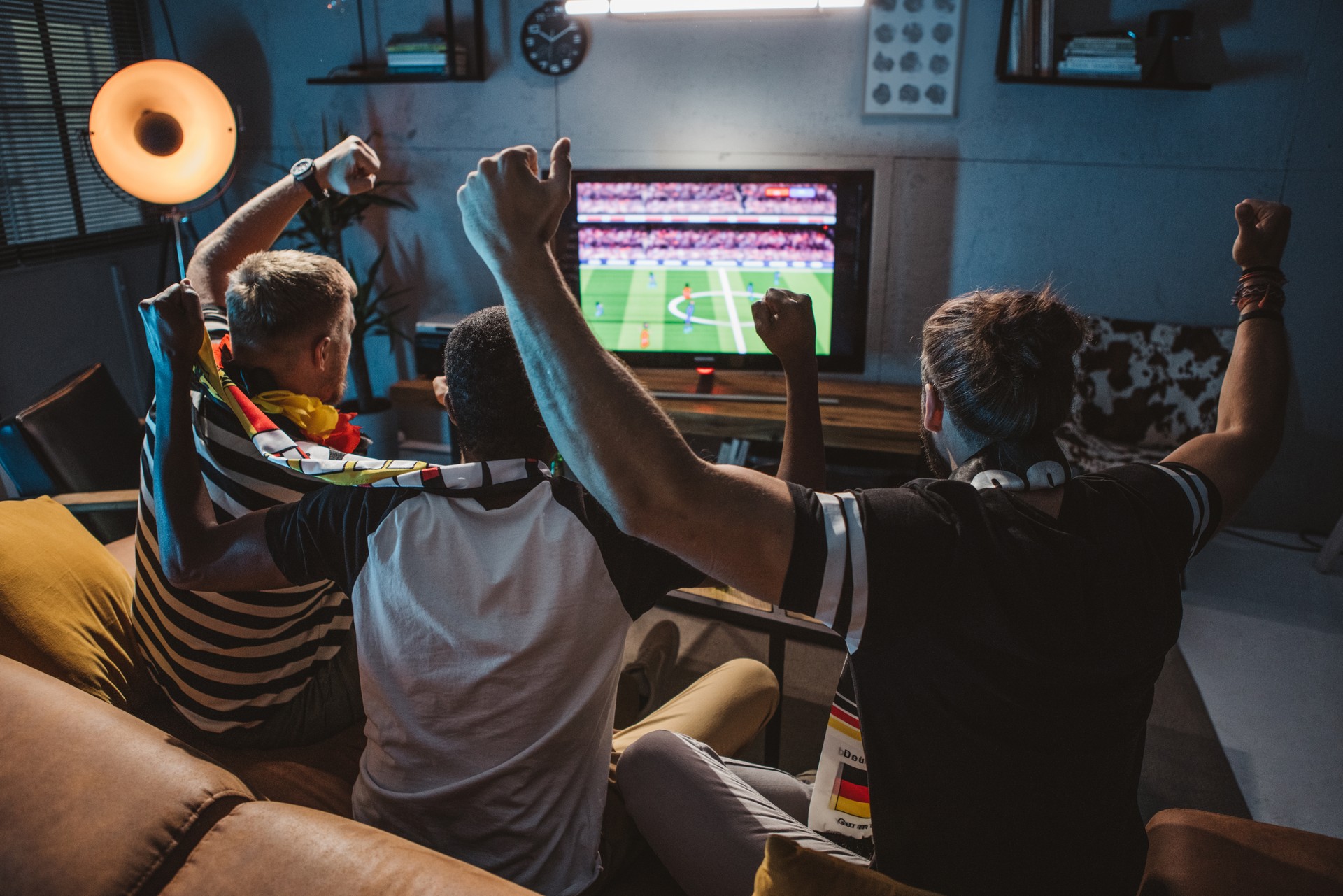 a group of soccer fans watching at home