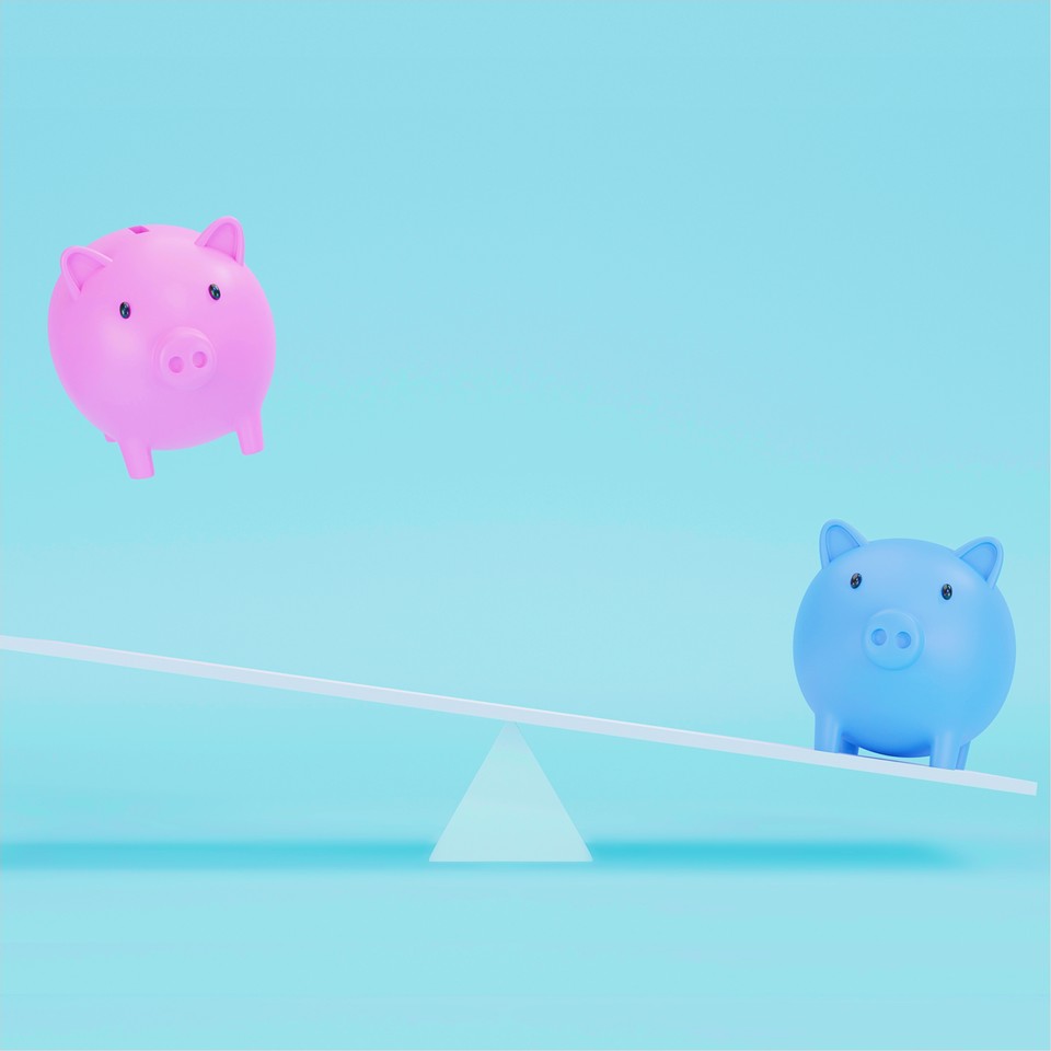 two piggy banks off-balanced on a scale