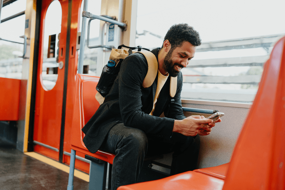 man with mobile device on a train