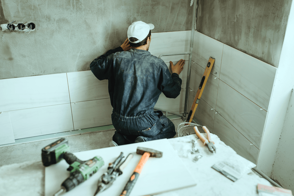 contractor installing bathroom tile