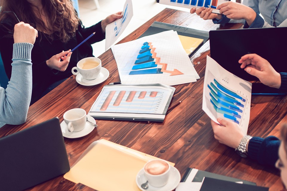 figures strategize around a table