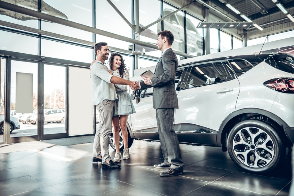 couple buying a new car