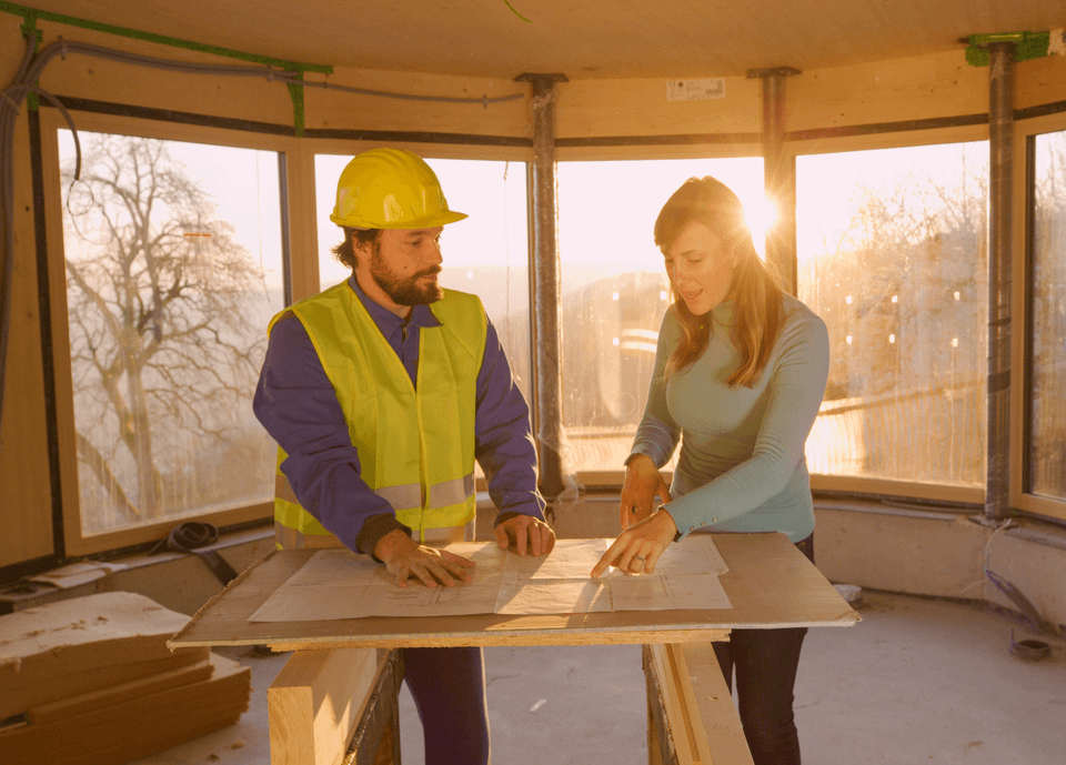 contractor reviewing plans with home owner