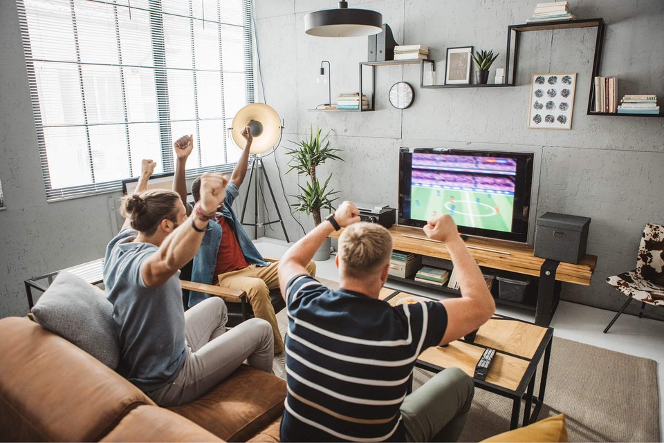 Cheering fans watching sports advertising