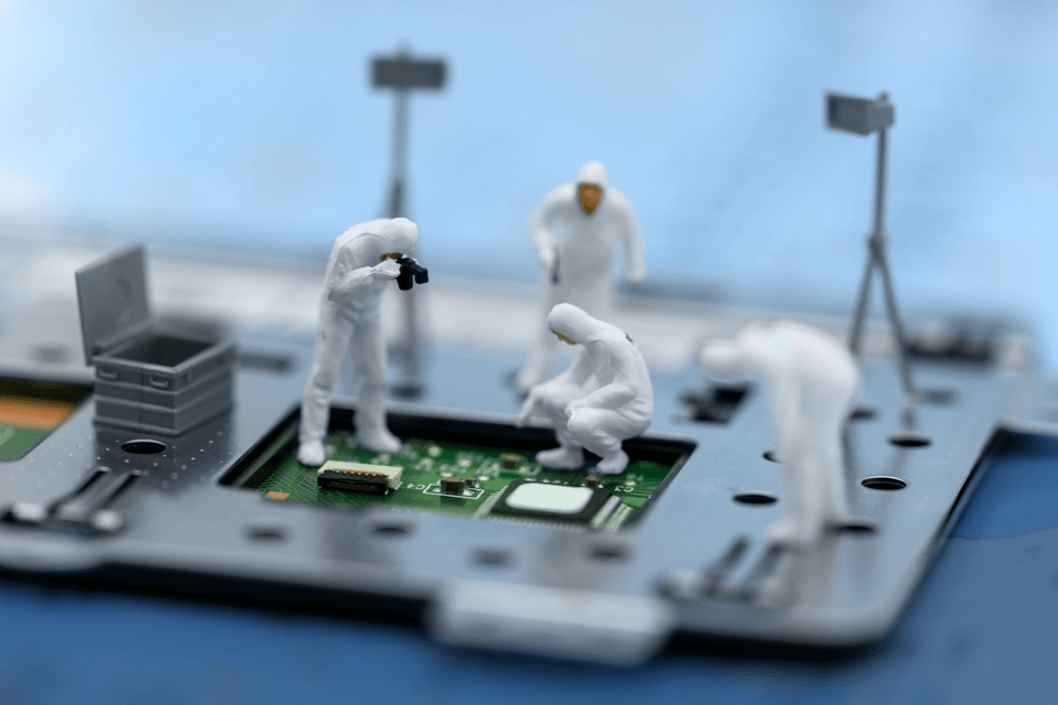 miniature men inspecting a hard drive