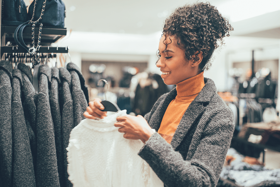 Woman holding a sweater in a store